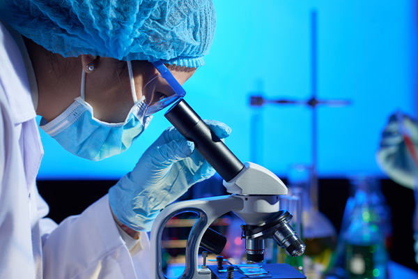 Lab scientist with microscope